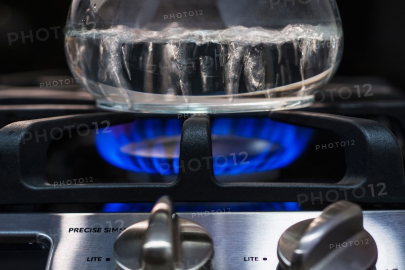 Close-up of water boiling on gas burner.