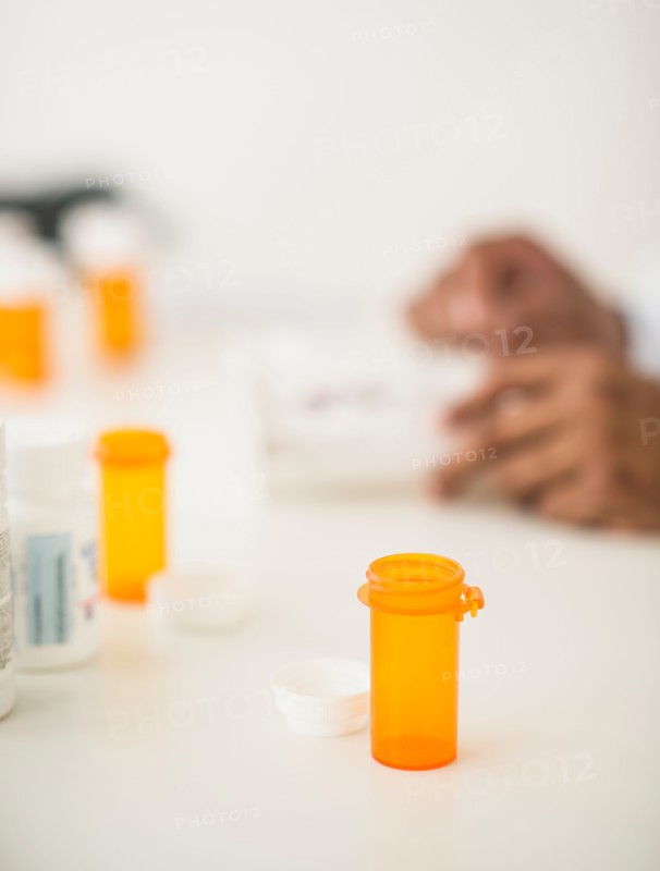 Pharmacist preparing prescription pills.