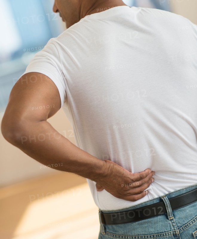 Man massaging his back.
