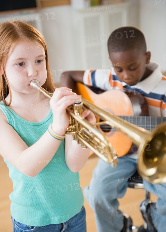 School children (8-9) with playing instruments during music class