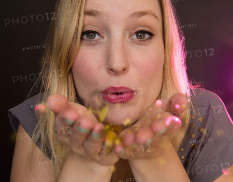 Portrait of young woman blowing kiss