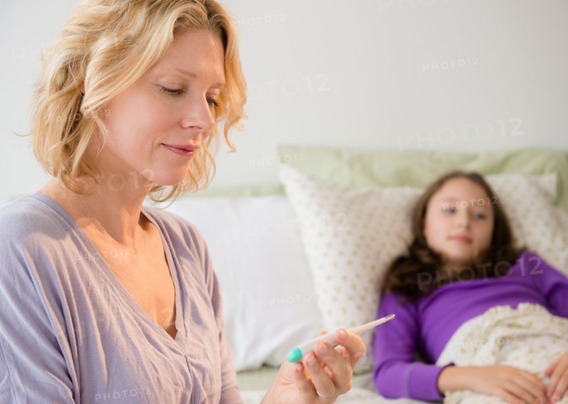 Mother checking temperature to daughter (8-9)