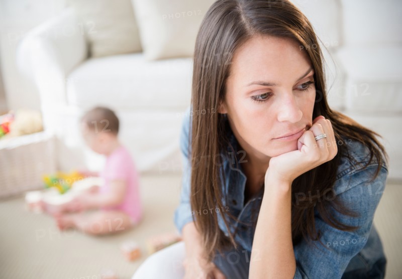 Mother with daughter (6-11 months) in living room