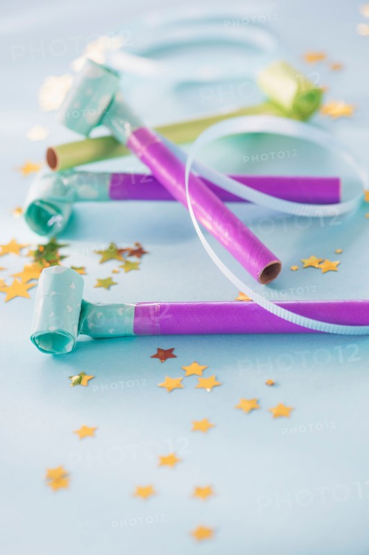 Studio shot of party blowers and confetti