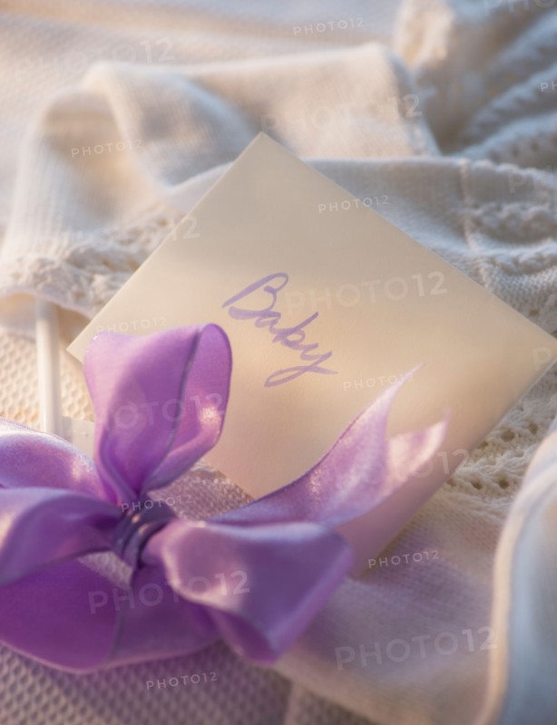 Close-up of envelope and purple bow