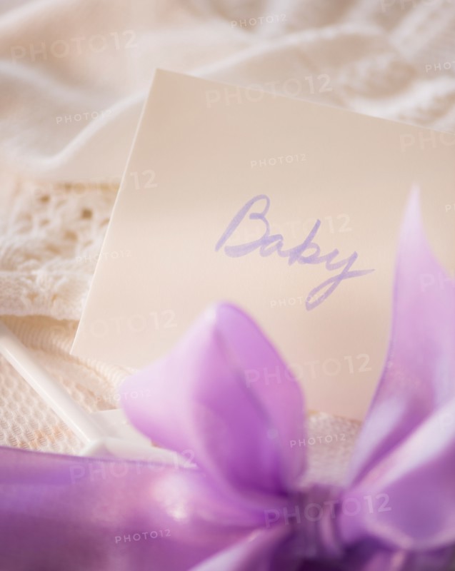 Close-up of envelope and purple bow