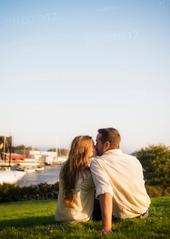 Couple kissing, harbor in background