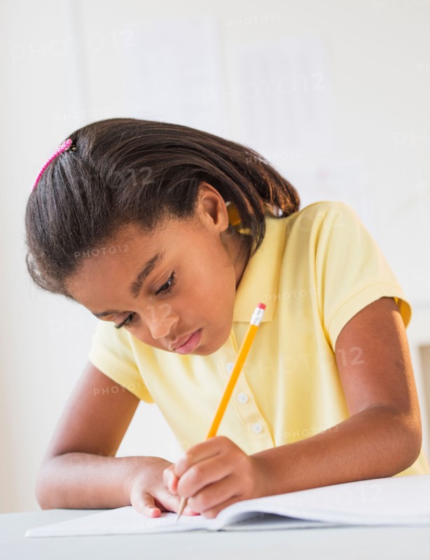 Girl (6-7) doing homework