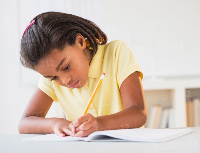 Girl (6-7) doing homework