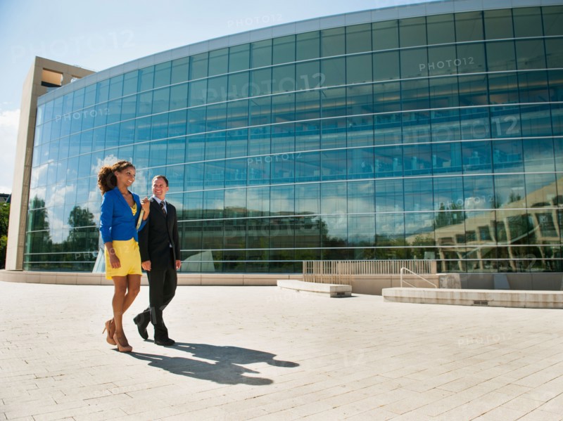 Man and woman walking outside office building