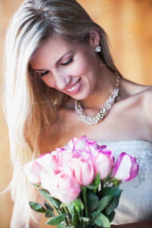 Portrait of smiling bride holding bouquet