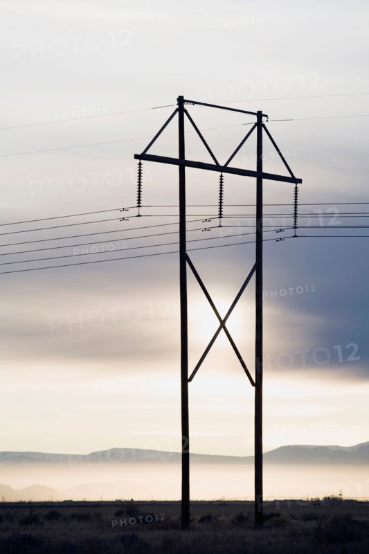 Power lines and tower at sunset