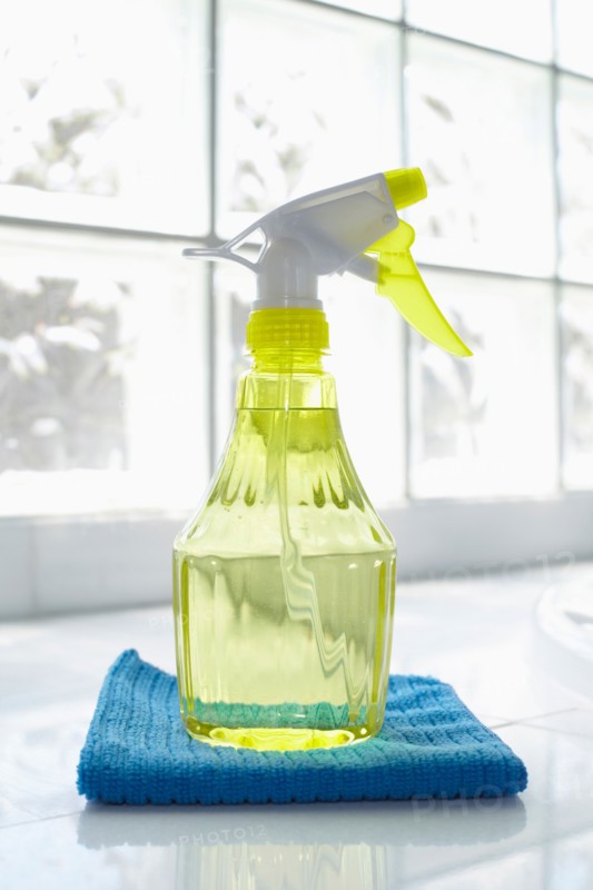 Cleaning supplies in front of glass brick wall