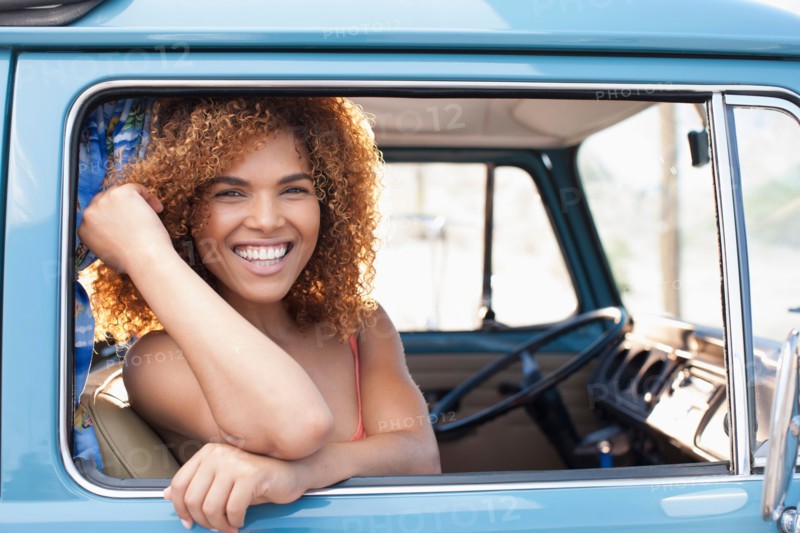 Portrait of smiling woman sitting in van