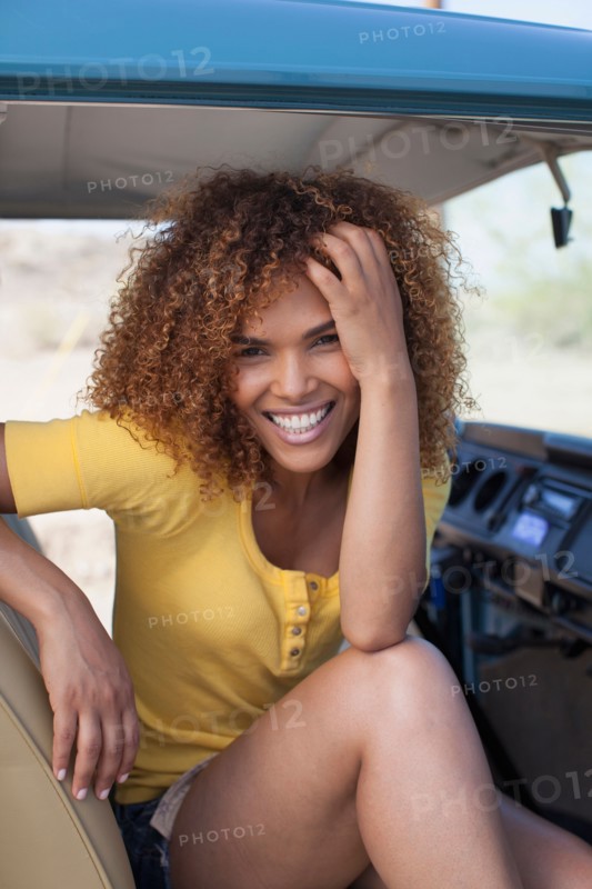 Portrait of smiling woman sitting in van