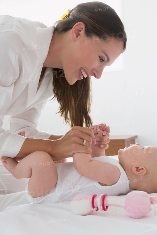 Smiling mother and baby daughter (6-11 months)