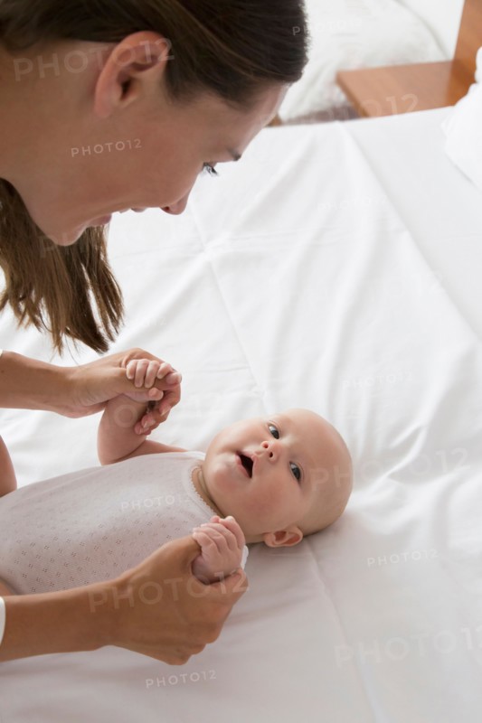 Smiling mother and baby daughter (6-11 months)