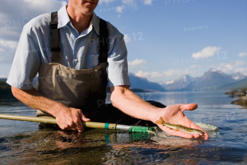 Man holding juvenile western cutthroat trout