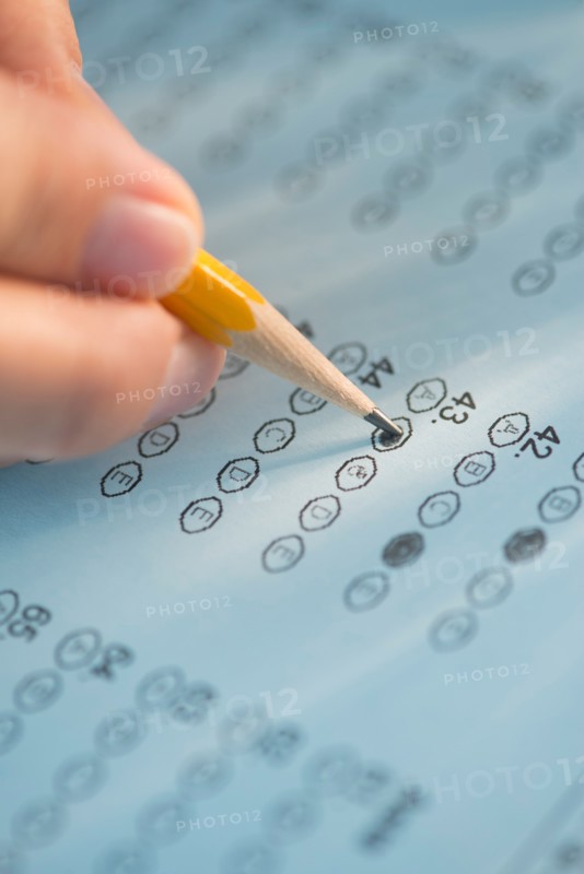Close-up of hand filling out test.