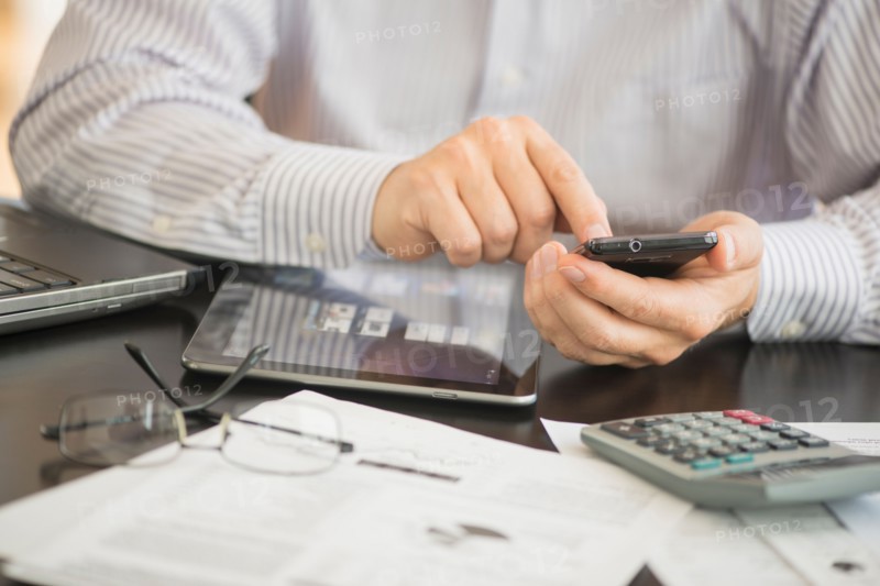 Man using tablet pc, laptop and smartphone.
