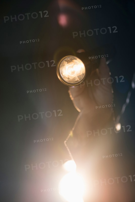 Hand holding flashlight.