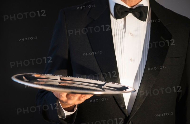 Waiter holding empty tray.