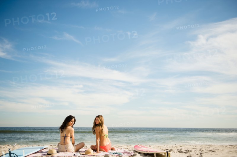 Two women relaxing on beach. Photo : Jamie Grill