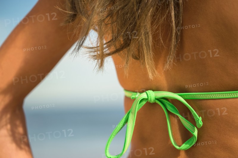 Woman sunbathing at beach. Photo : Jamie Grill