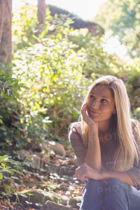 Woman sitting in forest. Photo: Jamie Grill