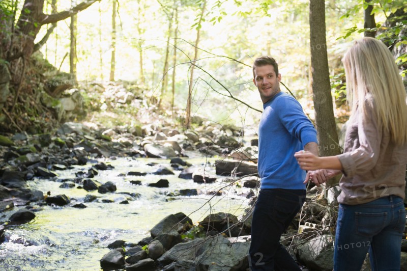 Couple walking by stream in forest. Photo: Jamie Grill