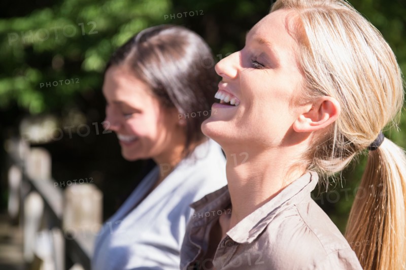 Two women smiling outdoors. Photo: Jamie Grill