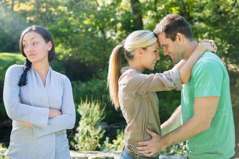 Couple and unhappy woman in forest. Photo : Jamie Grill