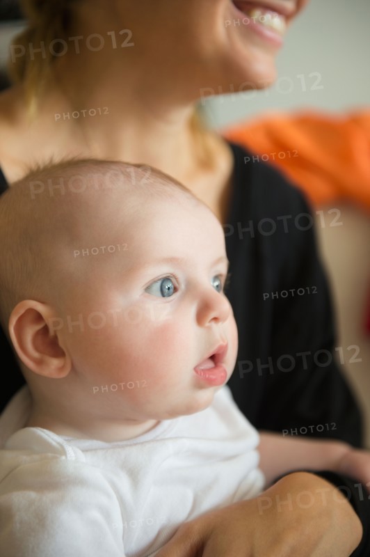 Baby boy (2-5 months) held by mother. Photo: Jamie Grill