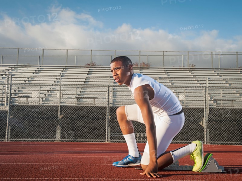 Boy (12-13) preparing for running on starting line. Photo: Erik Isakson