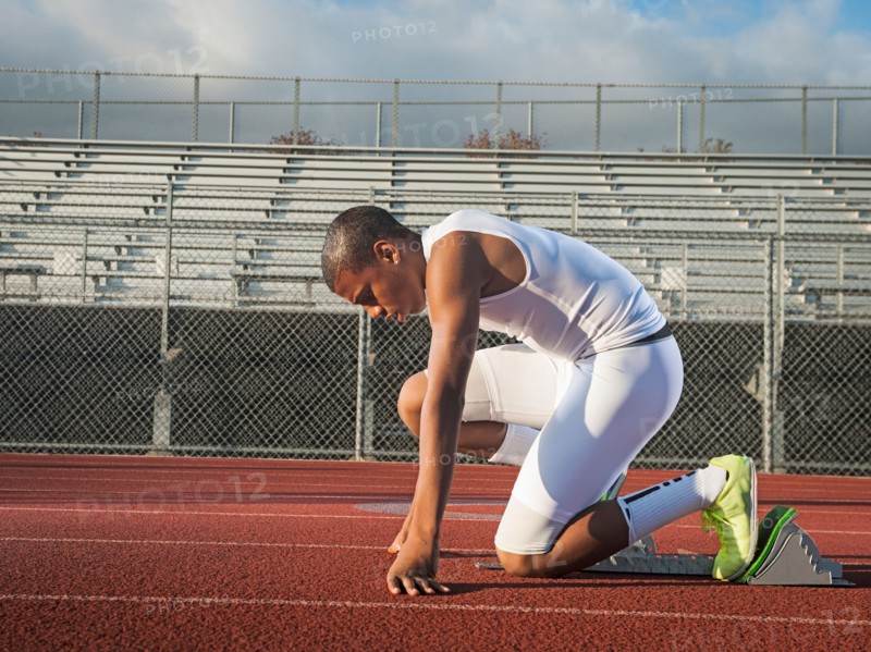 Boy (12-13) preparing for running on starting line. Photo: Erik Isakson