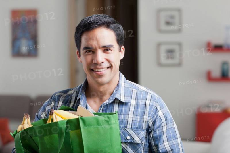 Portrait of man with shopping bags. Photo : Dan Bannister