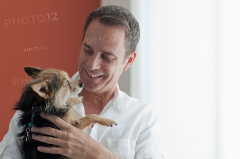 Mature man playing with dog. Photo: Dan Bannister