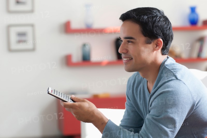 Man watching tv in living room. Photo: Dan Bannister