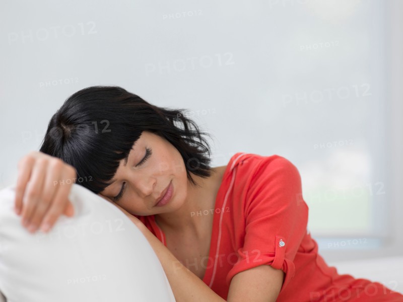 Young woman resting on sofa. Photo: Dan Bannister