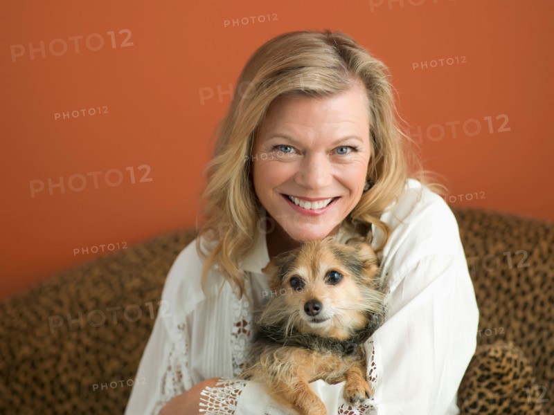 Mature woman playing with dog. Photo : Dan Bannister