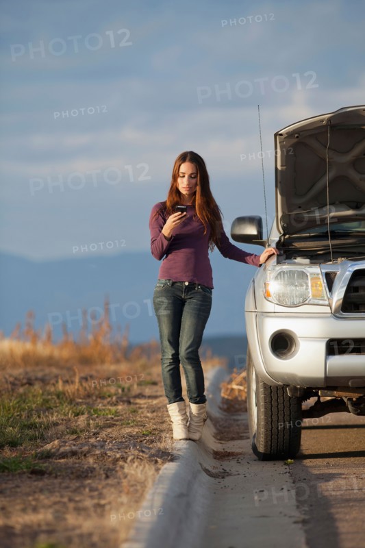 Woman calling for assistance after vehicle breakdown. Photo: Noah Clayton