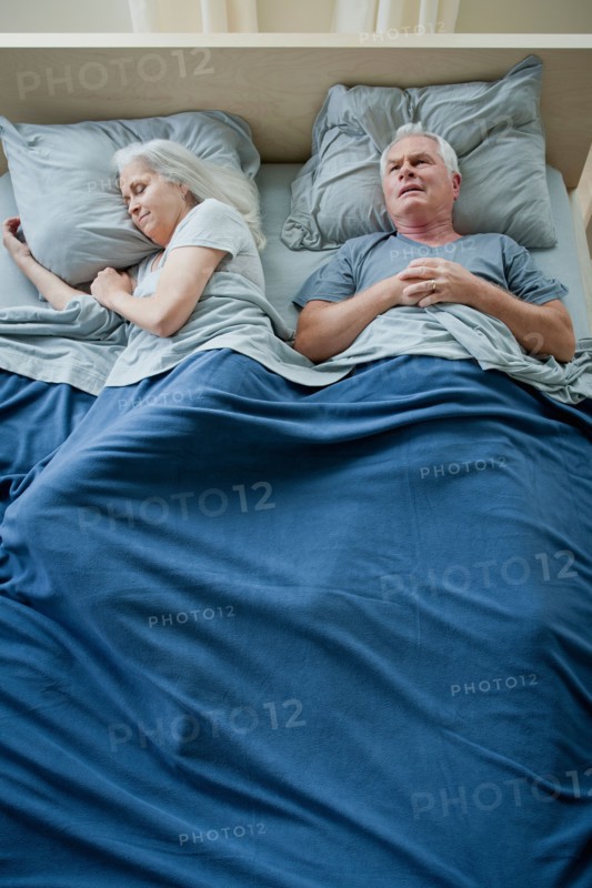 Senior couple sleeping in bed. Photo: Rob Lewine
