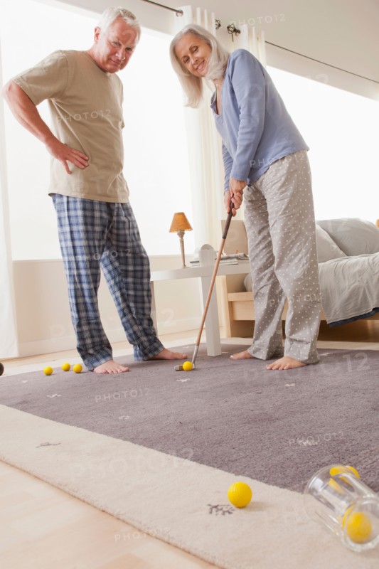 Senior couple playing mini golf at home. Photo: Rob Lewine