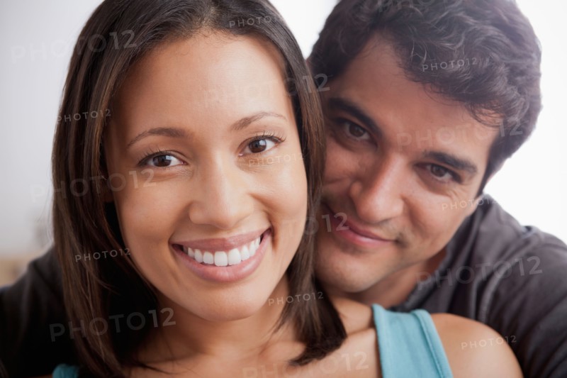 Smiling couple in close embrace. Photo: Rob Lewine