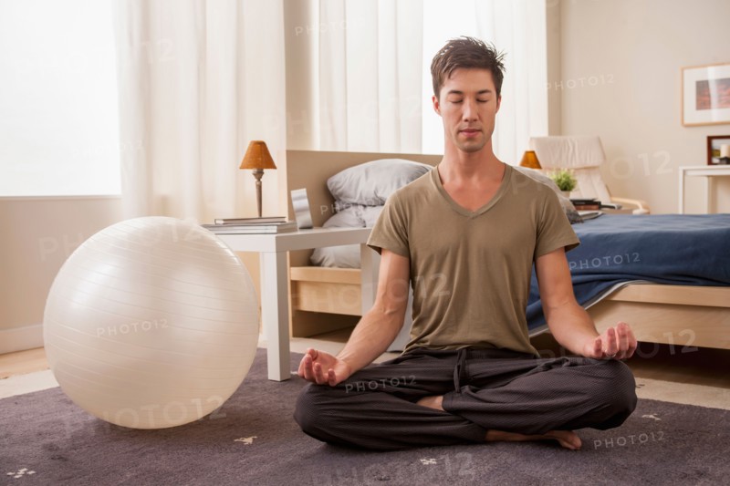 Portrait of man doing yoga. Photo : Rob Lewine