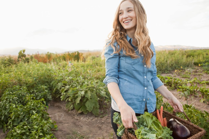 Portrait of young woman harvesting vegetables. Photo : Jessica Peterson