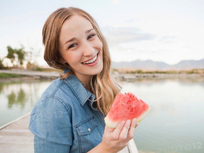 Portrait of young woman eating watermelon. Photo : Jessica Peterson