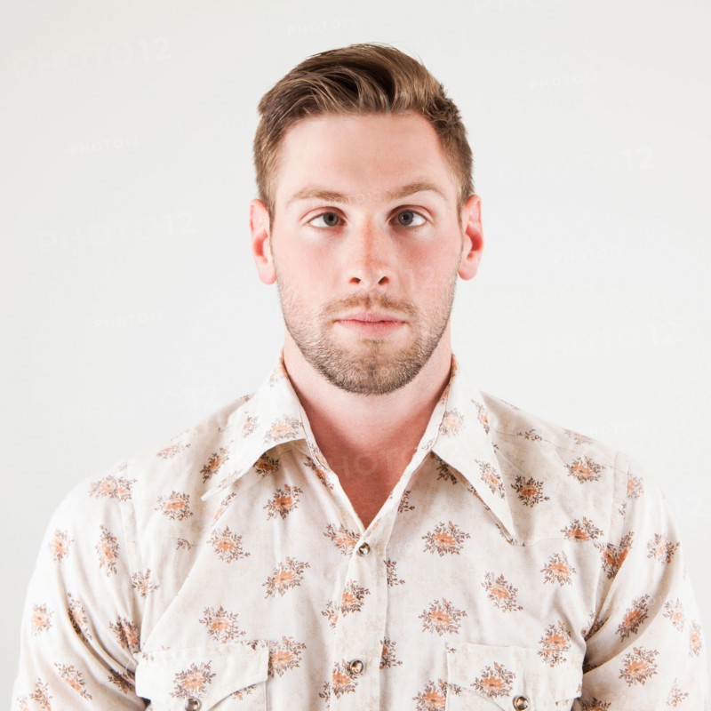 Studio portrait of cross-eyed man. Photo : Jessica Peterson