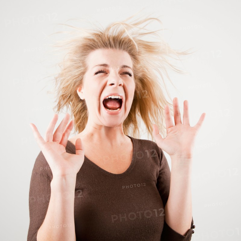 Studio shot of young woman screaming. Photo : Jessica Peterson