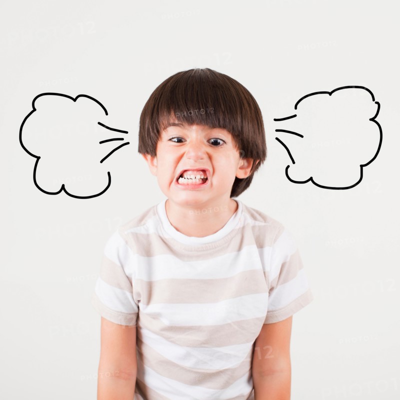 Studio shot of boy (6-7) with smoke puffs coming out of ears. Photo: Jessica Peterson